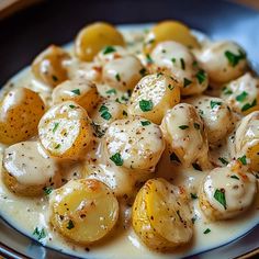 a white plate topped with potatoes covered in gravy