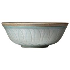 a white and blue bowl sitting on top of a table