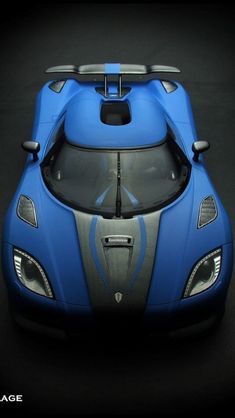 the front view of a blue sports car on a black background with its hood up