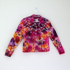 a colorful jacket hanging on a white wall