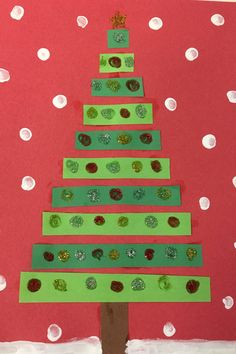 a christmas tree made out of construction paper on a red background with white polka dots