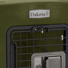 a green dog carrier with the door open