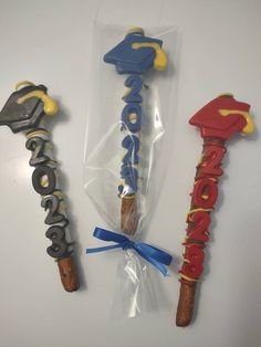 three different types of cookies in plastic bags on a white surface with blue and yellow ribbon