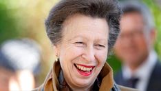 an older woman with grey hair smiling at the camera