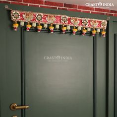 a green door with decorative decorations on the front and side panels that say crash india