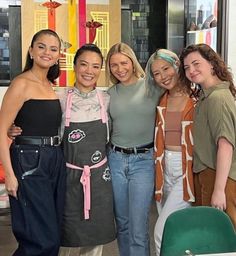 four women are posing for a photo together