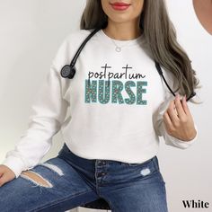 a woman with grey hair wearing a white shirt that says postpartum nurse on it