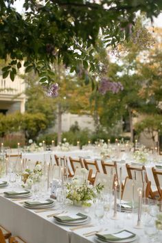 the tables are set for an outdoor wedding reception