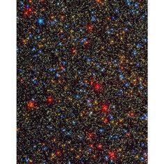 an image of the sky with many stars and small red, blue, and green dots