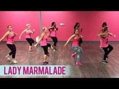 a group of women in pink shirts dancing