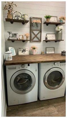 a washer and dryer in a room with shelves on the wall above them