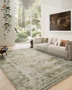 a living room with a large rug on the floor and a couch in front of it