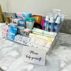 a counter top with a sign that says please off yourself on it and various items in the tray