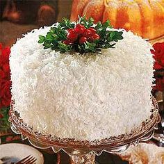 a large white cake on a silver platter