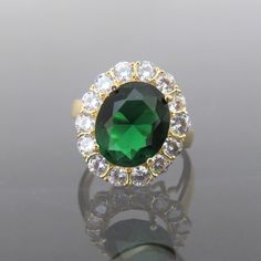 Vintage 18K Solid Yellow Gold Emerald & White Topaz Halo Ring ...Marked 18K...Total of weights 4.2grams...Size 7Measure of Face 18.2MM...It's in very good condition. #501836 Luxury Gold Emerald Ring With Cubic Zirconia, Elegant Gold Gemstones With Center Stone, Gold Oval Gemstones With Brilliant Cut, Gold Cubic Zirconia Cluster Ring With Gemstone, Luxury Gold Diamond Ring For May Birthstone, Formal Gold Emerald Crystal Ring, Hallmarked Gold Gemstones For Anniversary, Gold Emerald Gemstones With Accent Stones, Gold Cubic Zirconia Gemstones For Anniversary