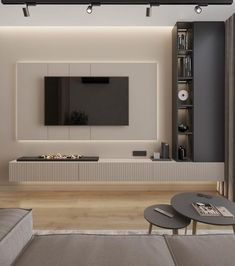 a living room with a couch, coffee table and television on the wall in front of it