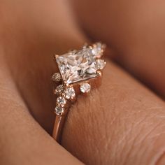 a woman's hand with a diamond ring on it