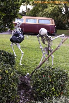 two skeletons are in the yard, one is holding an umbrella and the other has a bag