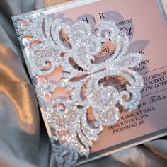 the wedding card is adorned with crystal beads