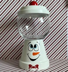 a snowman candy dispenser with a cherry on top