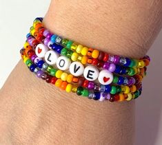 So wonderful to look at and fun to wear! This is a set of 5 brightly colored rainbow seed bead bracelets and one of them has the word LOVE. Each light weight, strong, stretchy. Easy to wear. Can be made to fit you perfectly in child through adult sizes. Beads may vary slightly from the ones shown. Purchasing this listing, you will get 5 strands of seed bead bracelets as seen in the 1st picture. This is a special NON personalized price. This listing is for 1 set of 5 bracelets all the same size. Pony Bead Bracelets, Beaded Braclets, Preppy Bracelets, Love Word, Pride Bracelet, Memorial Bracelet, Beads Bracelet Design, Jewelry Making Necklace, Rainbow Bracelet