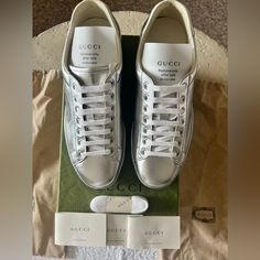 This Is A Pair Of Authentic Silver Metallic Leather Gucci Sneakers New In Box Men’s Size 7 Or Women’s Size 9.5/10 New In Box Thanks For Stopping By! Luxury Gucci Sneakers, Designer Gucci Sneakers With Embossed Logo, Classic Gucci Sneakers With Embossed Logo, Gucci Designer Calf Leather Sneakers, Classic Gucci Sneakers, Gucci Designer Sneakers For Formal Occasions, Gucci Designer Formal Sneakers, Gucci Ace Sneakers, Gucci Shoes Sneakers