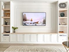 there is a painting on the wall in this living room with white cabinets and shelving