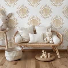 a wicker bench with pillows and stuffed animals on it in front of a wallpapered background