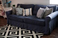 a blue couch with several pillows on it