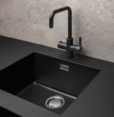 a black kitchen sink with faucet and soap dispenser