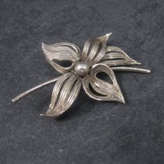 This beautiful flower brooch is sterling silver. Measurements: 1 5/16 by 1 7/8 inches Marks: Forstner, Sterling Condition: Excellent with patina The Forstner jewelry company was founded in 1920 in Irvington, New Jersey.  The  company later changed their name to the Forstner Jewelry Manufacturing Corporation. In 1980, the corporation ceased operations. Classic Flower Brooches For Anniversary, Silver Vintage Flower Brooches, Formal Flower Shaped Hallmarked Brooch, Vintage Sterling Silver Flower Brooches, Vintage Silver Flower Brooches, Jewelry Manufacturing, Turtle Brooch, Jewelry Pins, Glass Christmas Tree