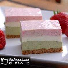 three pieces of cake on a plate with strawberries