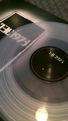 a record player's turntable sitting on top of a table with the sun shining through it