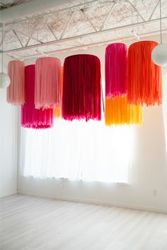 several different colored lights hanging from the ceiling