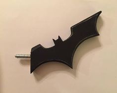 the bat symbol is attached to a screw