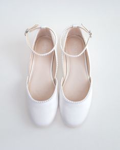 a pair of white shoes sitting on top of a table