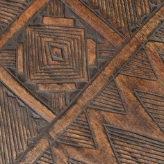 an intricate wooden surface with geometric designs on it