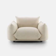 a white chair with a pillow on it's back and the seat upholstered