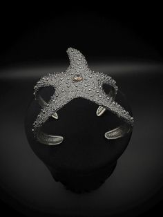 These Star Fish designed  jewelry is made of from 925k sterling silver which has a hypoallergenic quality, so people with metal allergies can wear it without experiencing any skin irritation. Also fully adjustable for all kind of wrist. During the completion of the jewelry, we create antique look and texture by oxidizing the silver. For the eyes of the octopus, I use zircon stones and bronze around them to look like realistic effect. It is handcrafted in 925k Sterling Silver. So it's Water, sweat, heat resistant (No Discoloring or Tarnishing). Silver Star-shaped Formal Jewelry, Silver Star-shaped Jewelry For Formal Occasions, Silver Star-shaped Jewelry For Formal Events, Elegant Silver Starfish Jewelry, Elegant Nickel-free Starfish Jewelry, Elegant Starfish Bracelet For Gift, Elegant Starfish-shaped Nickel-free Jewelry, Luxury Silver Adjustable Cuff Bracelet, Luxury Starfish-shaped Jewelry Gift