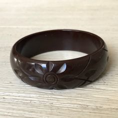 "Lovely old bakelite (tested) bangle bracelet in rich chocolate brown. Approx. 7/8\" wide with a carved floral design. 2.5\" opening. Good vintage condition with light wear. See more bakelite here: http://www.etsy.com/shop/veraviola/search?search_query=bakelite&search_type=user_shop_ttt_id_5813259&shopname=veraviola Please visit my shop for more vintage finds! http://www.veraviola.etsy.com" Vintage Brown Bangle As A Gift, Brown Adjustable Bangle, Brown Carved Bangle Bracelets, Brown Bakelite Jewelry As A Gift, Vintage Brown Carved Bracelets, Vintage Carved Brown Bracelets, Brown Bakelite Bangle Bracelet, Bakelite Bracelets, 14k Gold Wedding Band