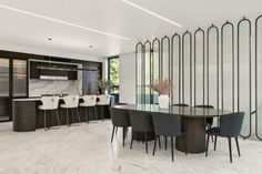 an elegant dining room with marble flooring and white walls, along with bar stools