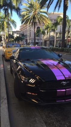 two cars are parked on the side of the street with purple stripes painted on them