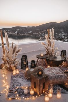 an outdoor seating area with candles and lights