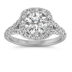 an engagement ring with a cushion cut diamond in the center