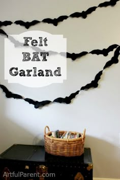 the wall is decorated with black string and has a sign that says felt bat garland