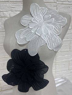 a mannequin with black and white flower appliques on it's chest