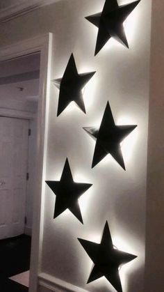 some black stars are hanging on the wall