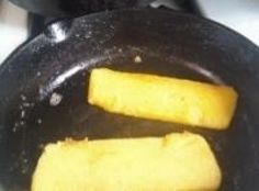 two pieces of food cooking in a frying pan