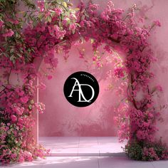 an arch covered in pink flowers with the word ad above it and a black circle on top