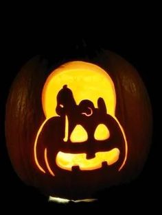 a pumpkin carved to look like a dog and cat sitting on it's side